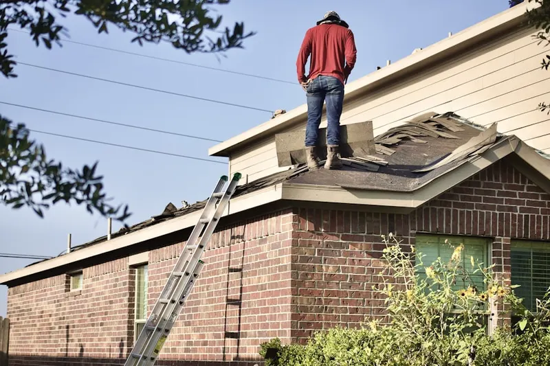 Professional roofer working on a residential roof in Town and Country